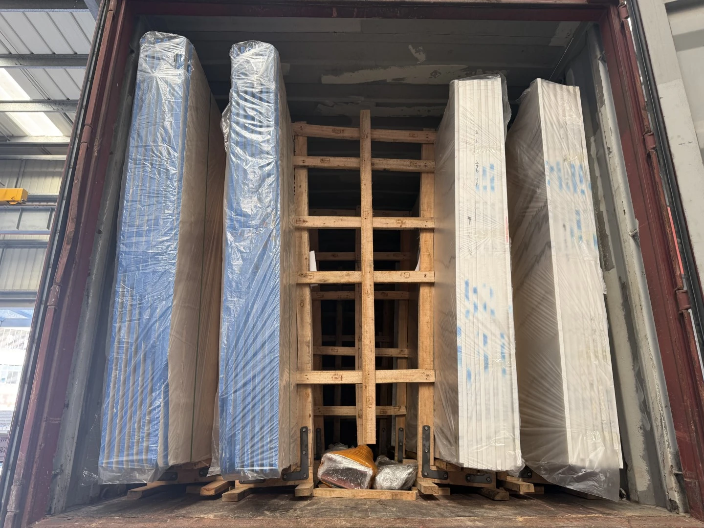 Completed loading of the second container with wrapped marble and Classic Beige Travertine slab bundles secured on export frames. Completed loading of the second container with wrapped marble and Classic Beige Travertine slab bundles secured on export frames.